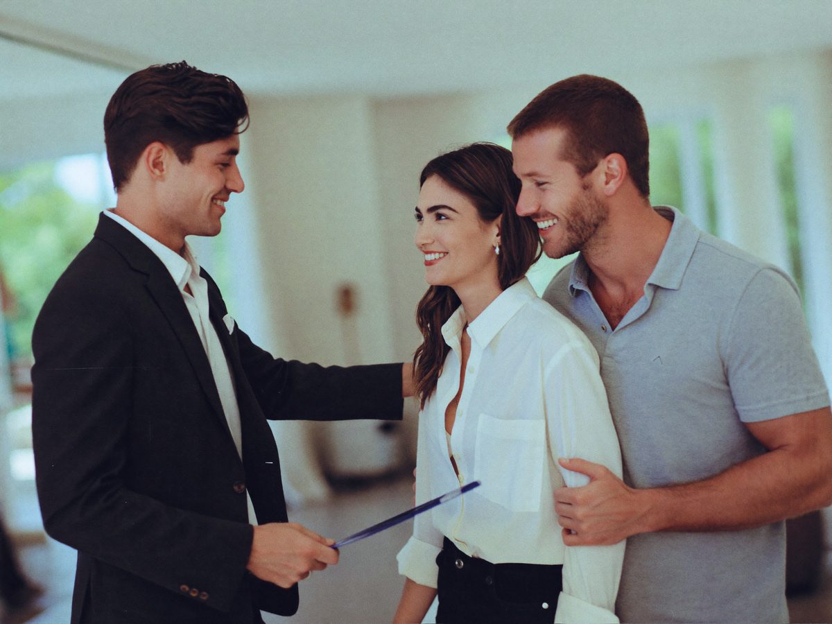 A realtor showing a home while her assistant coordinates the showings